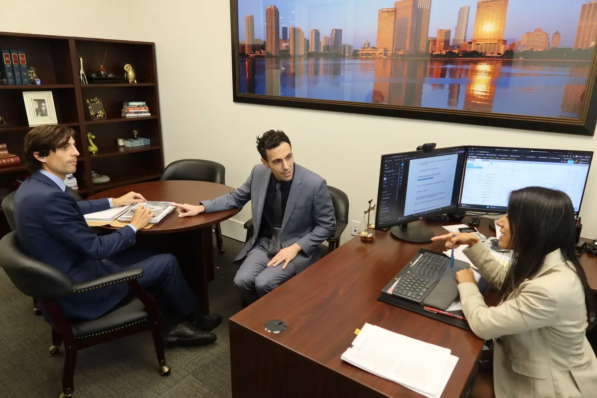 Attorneys Sean Cordero, Stephen Cordero and Miriam Marenco discussing a client’s case